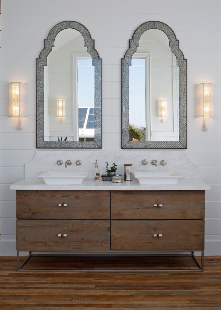 Inspiration for a country master bathroom in San Diego with flat-panel cabinets, distressed cabinets, white walls, medium hardwood floors and a vessel sink.