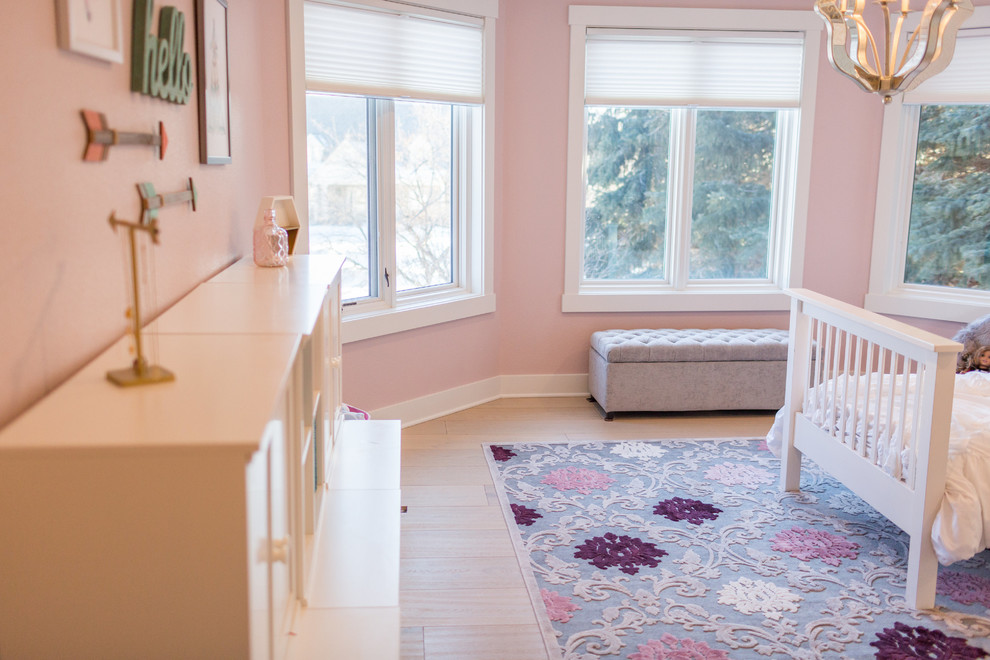 This is an example of a mid-sized transitional kids' room for kids 4-10 years old and girls in Other with pink walls, travertine floors and beige floor.