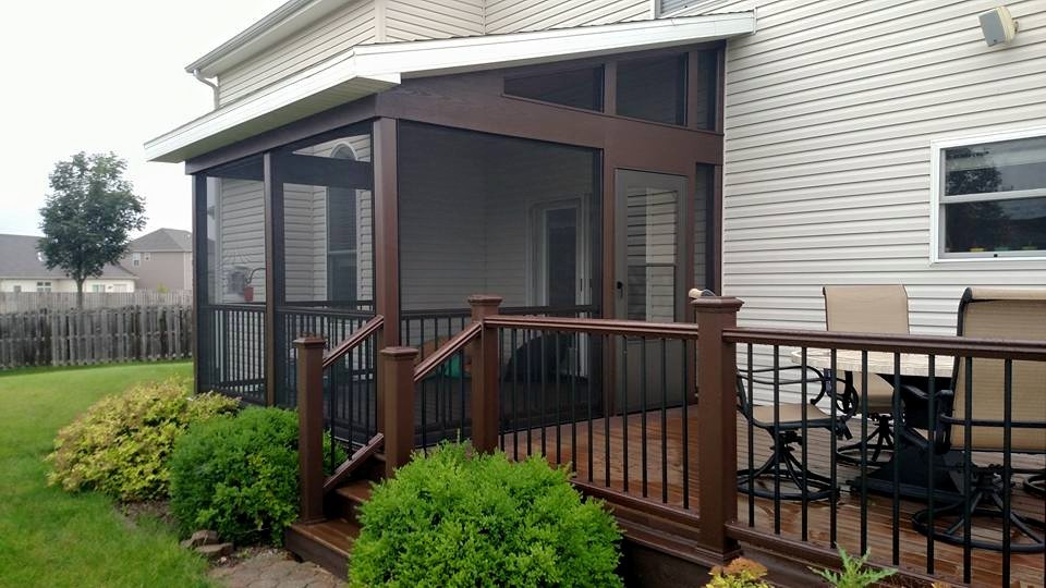 Example of a large transitional backyard deck design with a roof extension