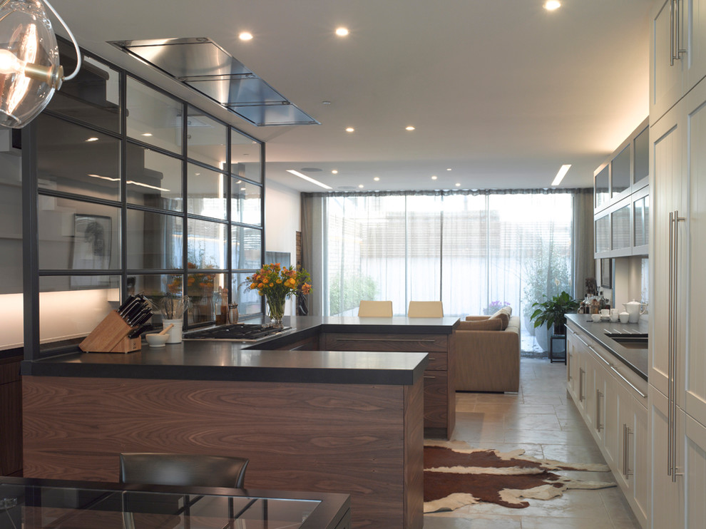 Inspiration for a mid-sized contemporary kitchen in London with an undermount sink, flat-panel cabinets, grey cabinets, solid surface benchtops, stainless steel appliances and with island.
