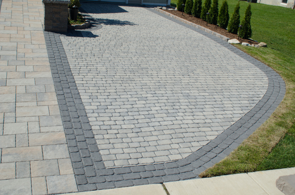 Inspiration for a traditional front yard driveway in Philadelphia with concrete pavers.