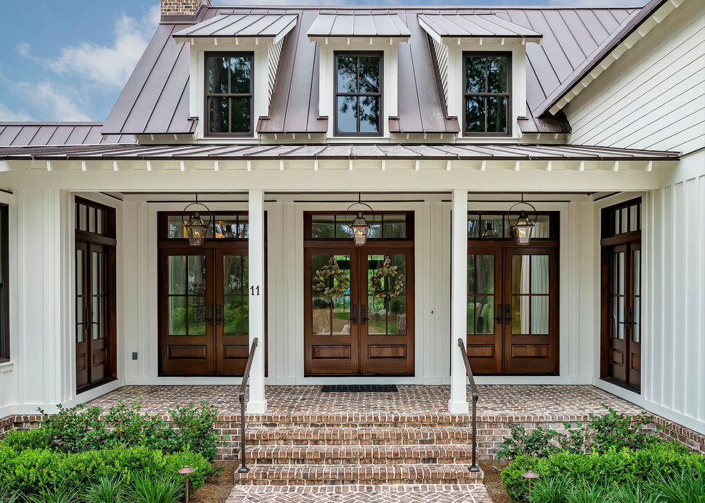 This is an example of a large country front door in Atlanta with a double front door and a dark wood front door.