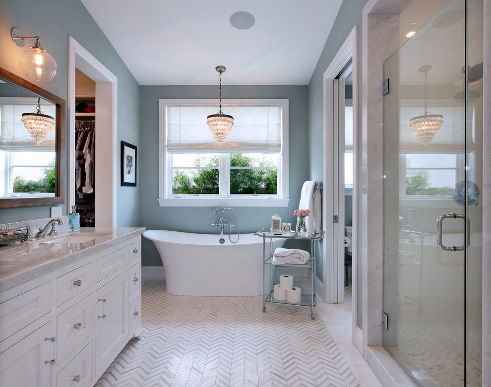 Inspiration for a transitional bathroom in Orange County with white cabinets, a freestanding tub, an alcove shower, grey walls, an undermount sink, recessed-panel cabinets and a hinged shower door.