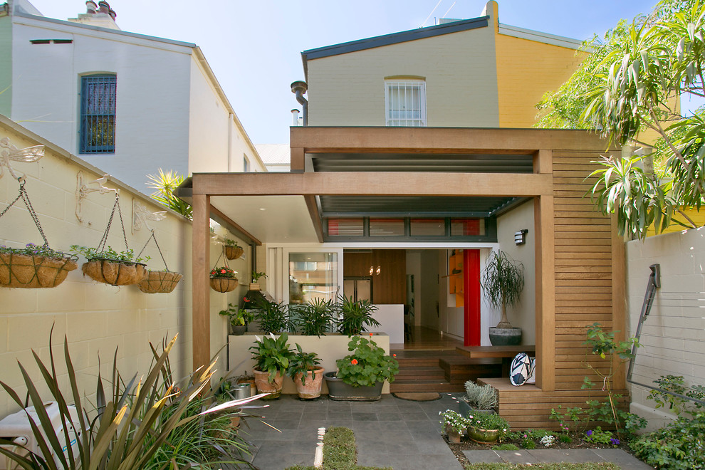 Photo of a contemporary patio in Sydney with a roof extension.