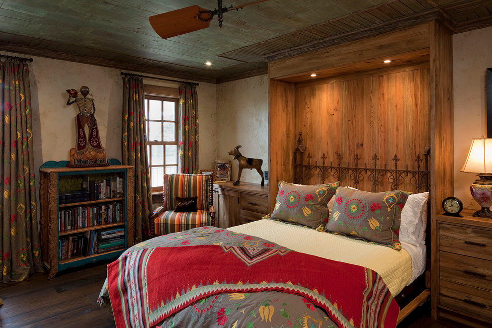 Inspiration for a country bedroom in Austin with dark hardwood floors.