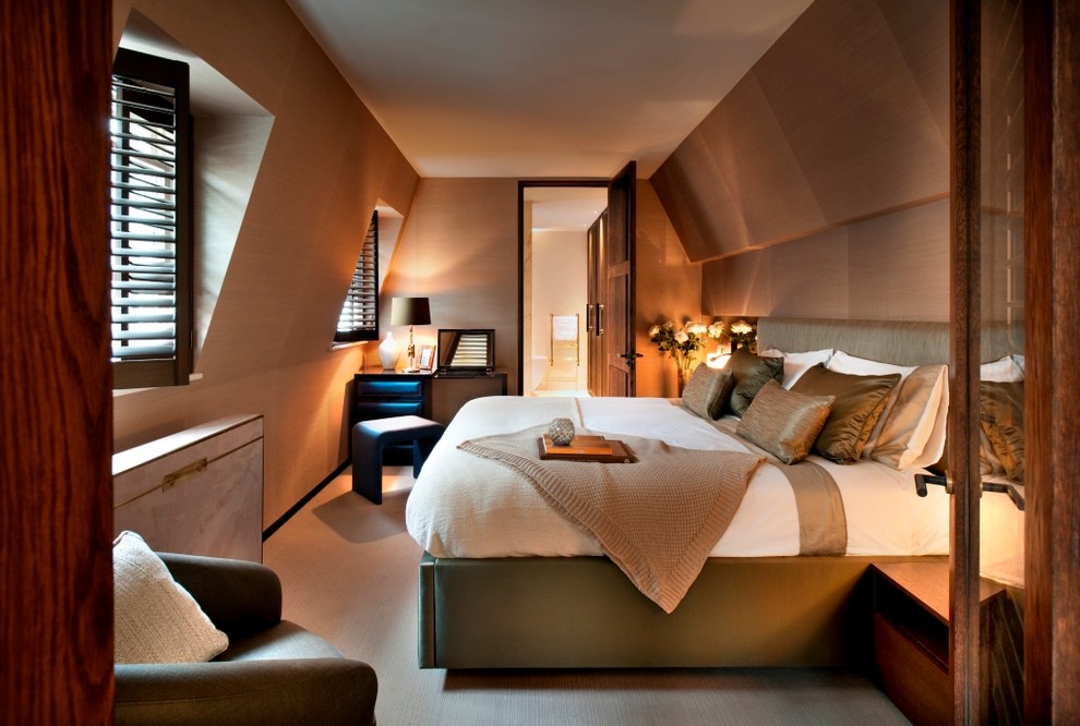 This is an example of a contemporary bedroom in London with carpet and brown walls.