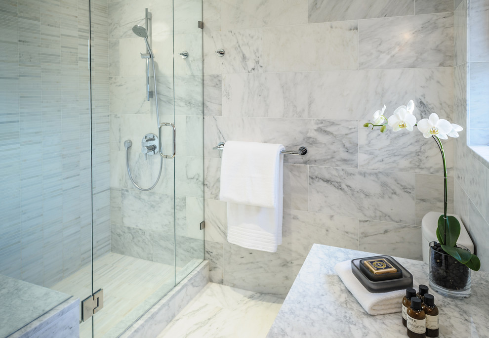 This is an example of a mid-sized contemporary 3/4 bathroom in Vancouver with flat-panel cabinets, medium wood cabinets, an alcove shower, a two-piece toilet, gray tile, white tile, porcelain tile, porcelain floors, an undermount sink and marble benchtops.