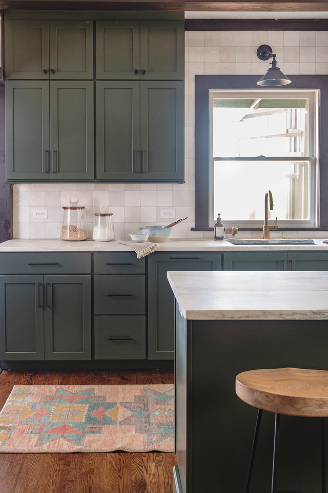 Inspiration for a mid-sized galley dark wood floor, brown floor and exposed beam enclosed kitchen remodel in Birmingham with an undermount sink, shaker cabinets, green cabinets, marble countertops, white backsplash, ceramic backsplash, stainless steel appliances, a peninsula and white countertops