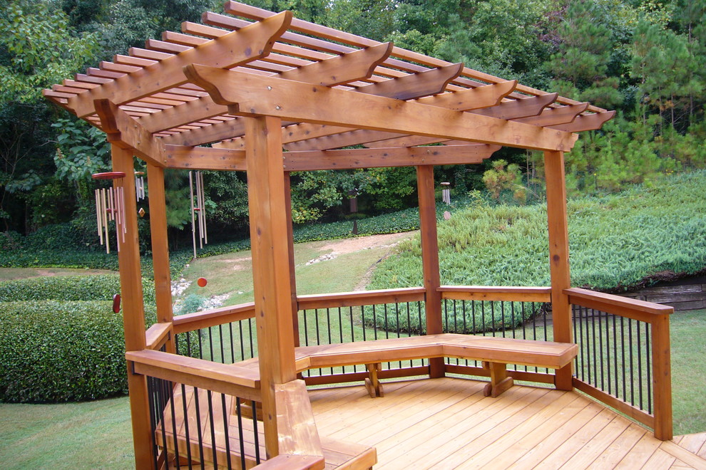 Design ideas for a mid-sized transitional backyard deck in Atlanta with a pergola.