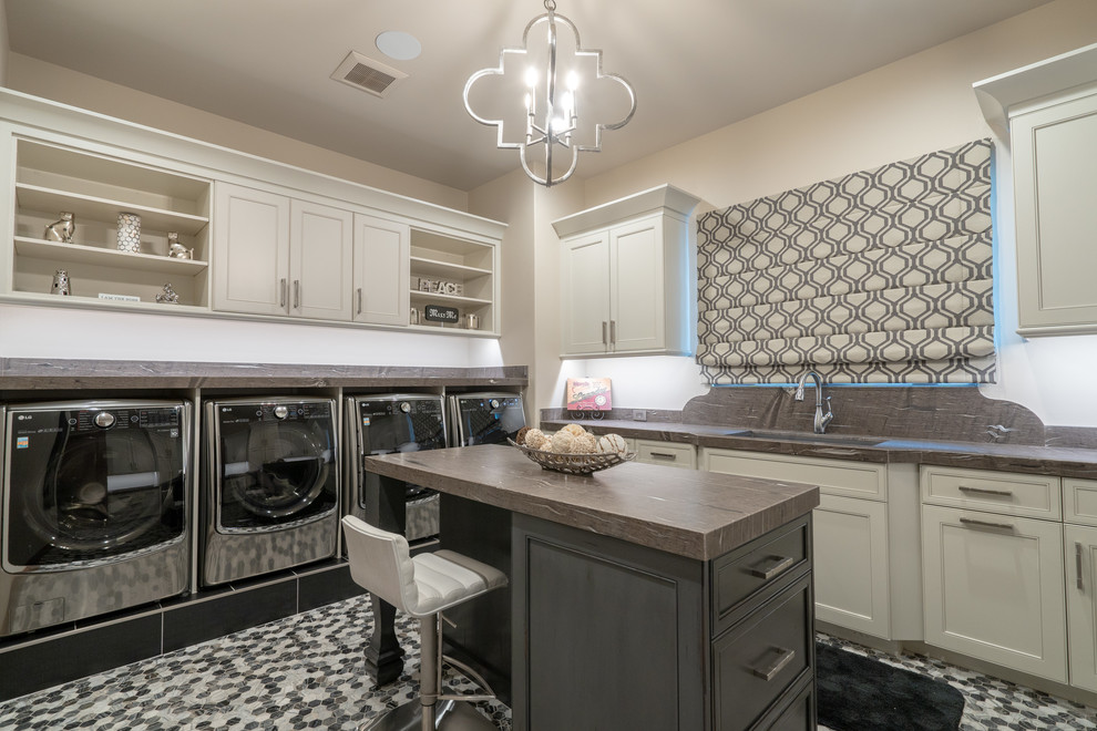 Design ideas for a dedicated laundry room in Phoenix with an undermount sink, recessed-panel cabinets, beige cabinets, beige walls, a side-by-side washer and dryer, multi-coloured floor and brown benchtop.