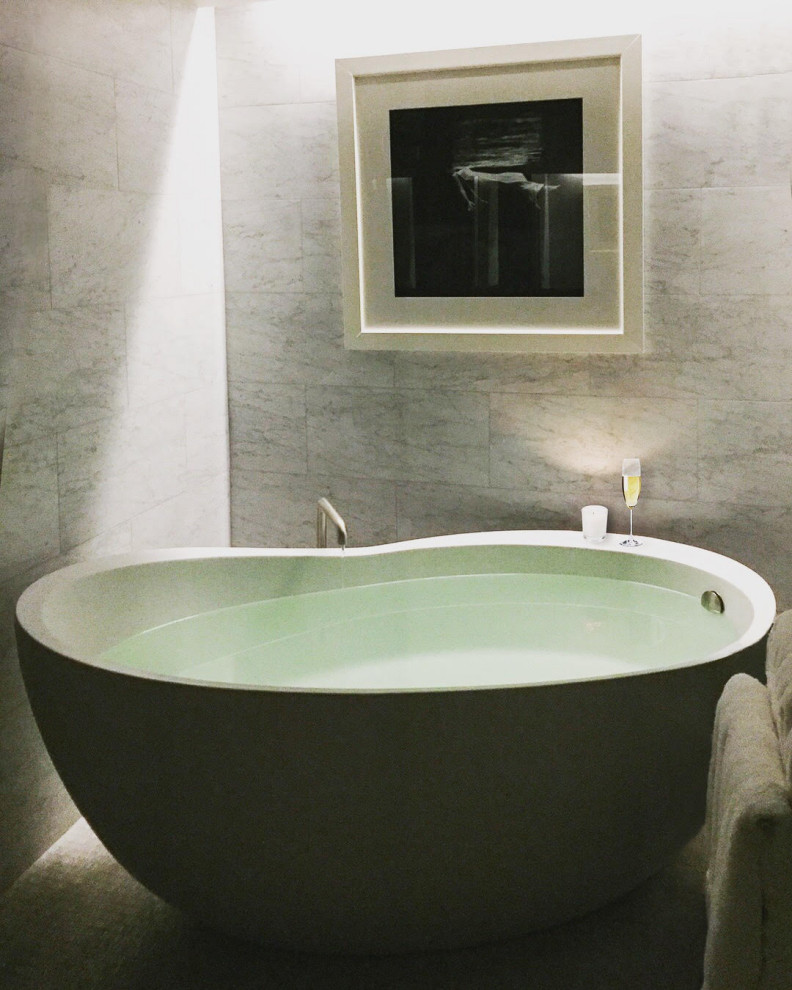 Inspiration for a large transitional master gray tile and stone tile freestanding bathtub remodel