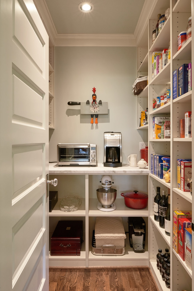 Kitchen pantry - mid-sized modern u-shaped medium tone wood floor kitchen pantry idea in Seattle with open cabinets, white cabinets, marble countertops, stainless steel appliances and no island