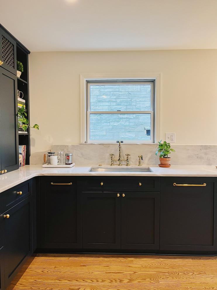 Eat-in kitchen - large transitional l-shaped medium tone wood floor and brown floor eat-in kitchen idea with an undermount sink, shaker cabinets, blue cabinets, quartzite countertops, stone slab backsplash, paneled appliances, no island and gray countertops