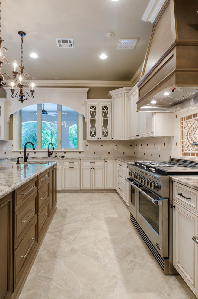 Inspiration for a large traditional u-shaped separate kitchen in New Orleans with an undermount sink, recessed-panel cabinets, white cabinets, quartzite benchtops, multi-coloured splashback, mosaic tile splashback, stainless steel appliances, marble floors, with island, beige floor and beige benchtop.