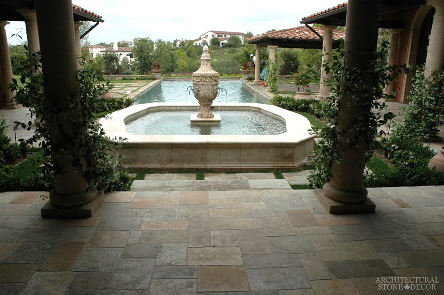 Design ideas for an expansive mediterranean courtyard patio in Toronto with a water feature, natural stone pavers and no cover.