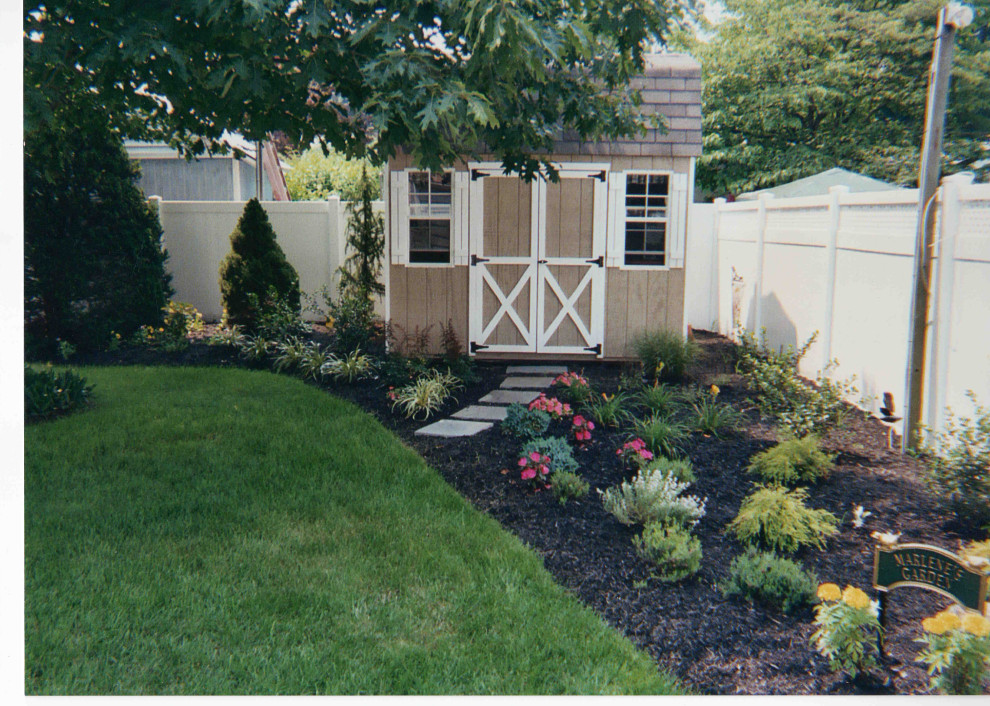 Backyard Garden planting with evergreens, perennials and annuals.