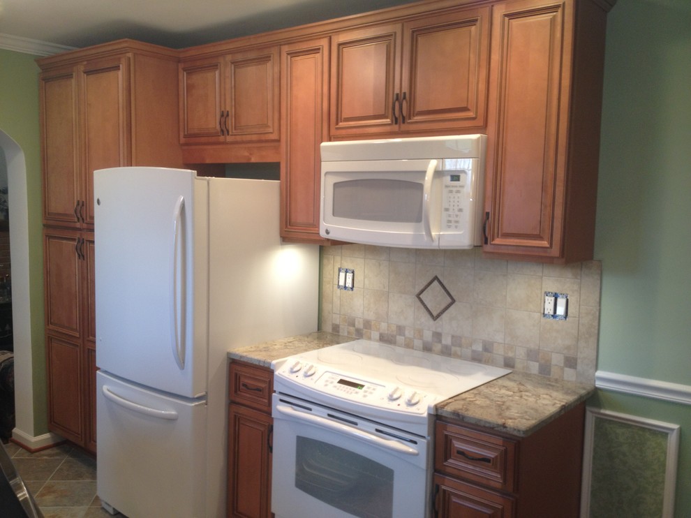 Example of a kitchen design in DC Metro with beaded inset cabinets, medium tone wood cabinets and beige backsplash