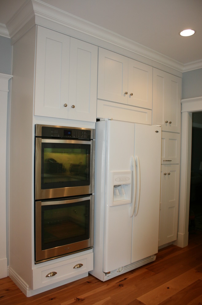 Transitional home design photo in Nashville with flat-panel cabinets, white cabinets and granite countertops