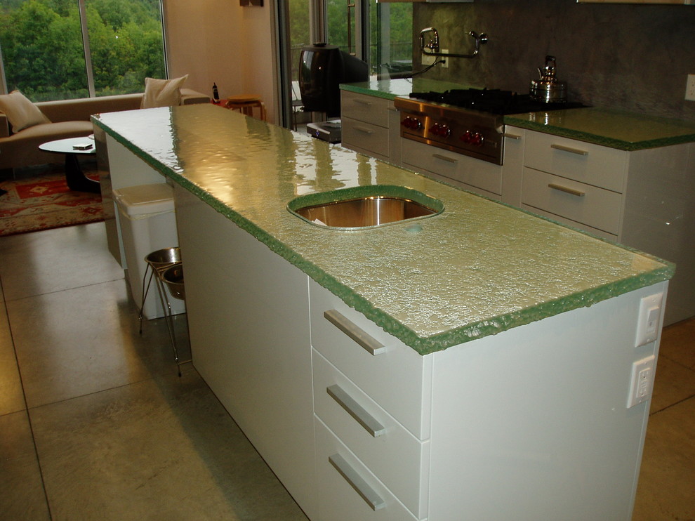 Inspiration for a contemporary l-shaped eat-in kitchen in New York with an integrated sink and glass benchtops.