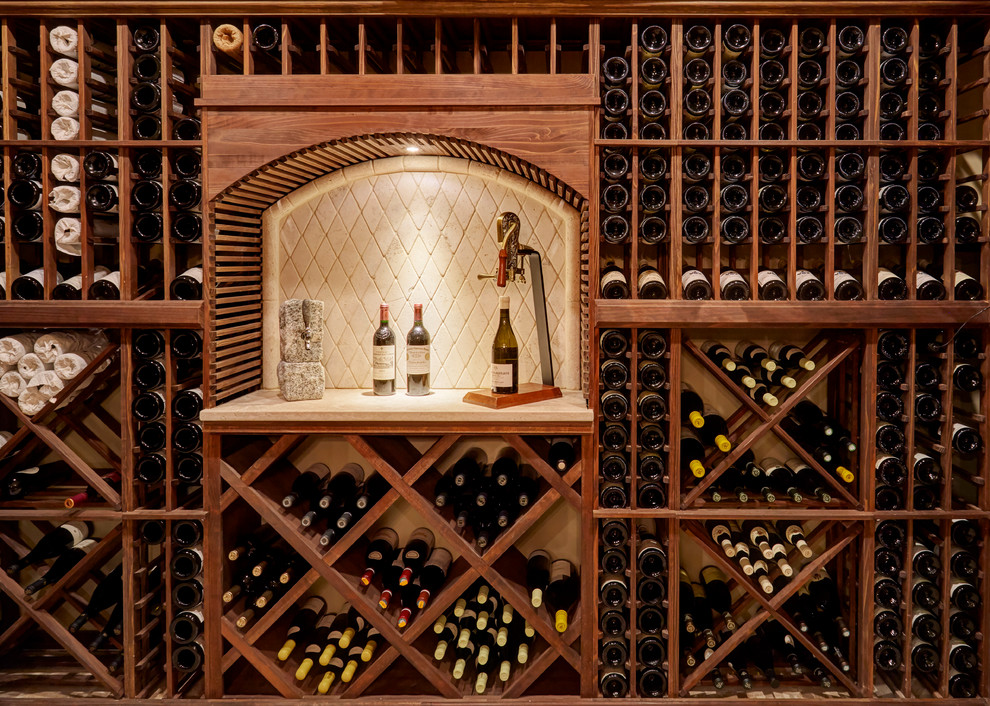 Photo of a mid-sized traditional wine cellar in Milwaukee with limestone floors and diamond bins.
