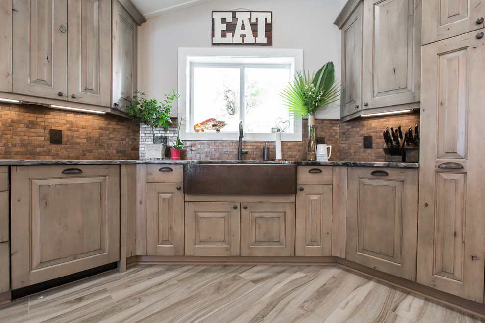 Design ideas for a large traditional eat-in kitchen in Tampa with raised-panel cabinets, distressed cabinets, copper benchtops, stainless steel appliances, porcelain floors and with island.