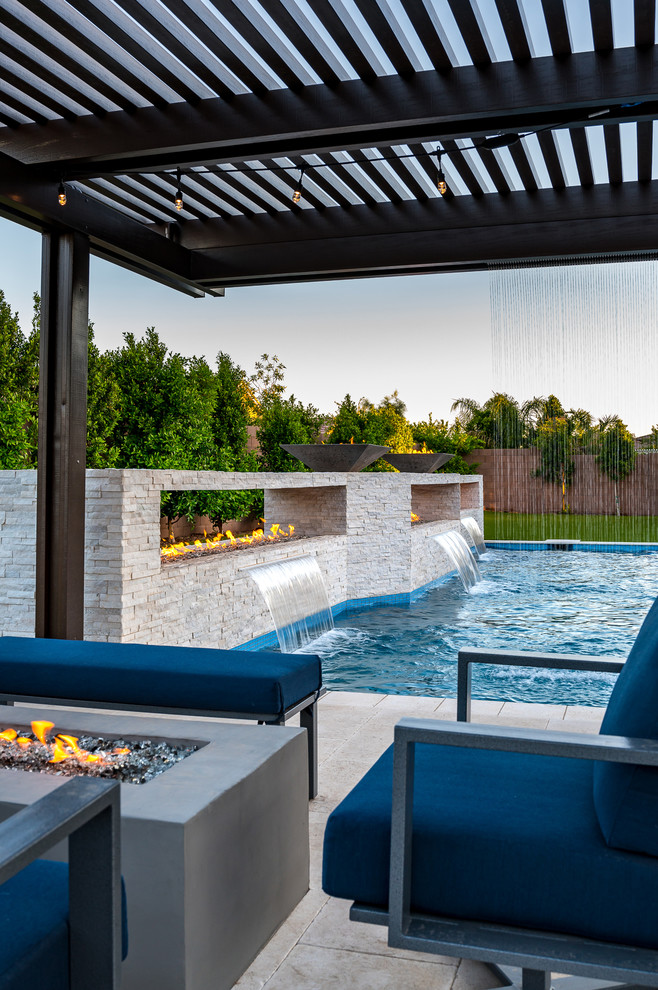 This is an example of a large modern backyard rectangular pool in Phoenix.