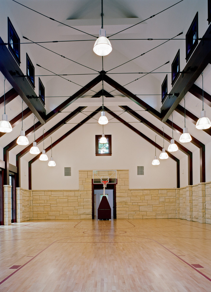 Contemporary indoor sport court in Detroit with white walls and light hardwood floors.