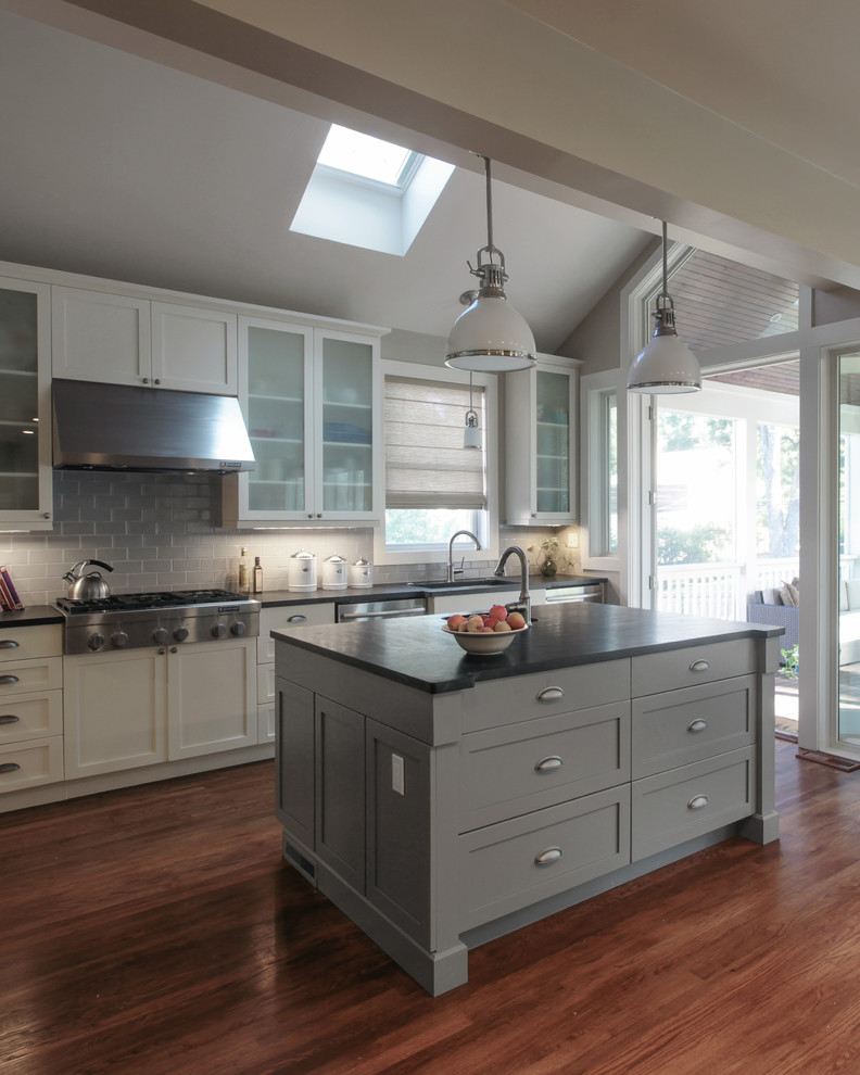 Open concept kitchen - mid-sized transitional single-wall dark wood floor open concept kitchen idea in DC Metro with an undermount sink, recessed-panel cabinets, gray cabinets, soapstone countertops, gray backsplash, subway tile backsplash, stainless steel appliances and an island