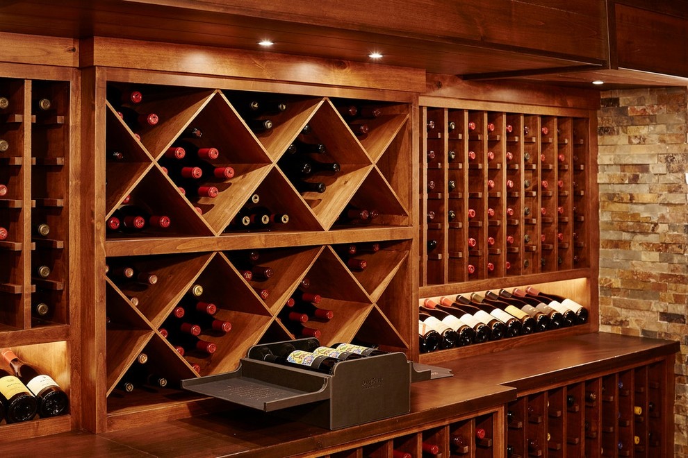 This is an example of a large traditional wine cellar in Minneapolis with slate floors, grey floor and display racks.