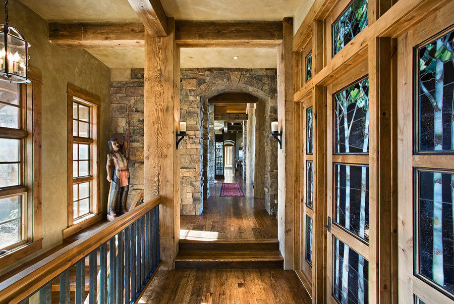 Hallway - large rustic dark wood floor and brown floor hallway idea with brown walls