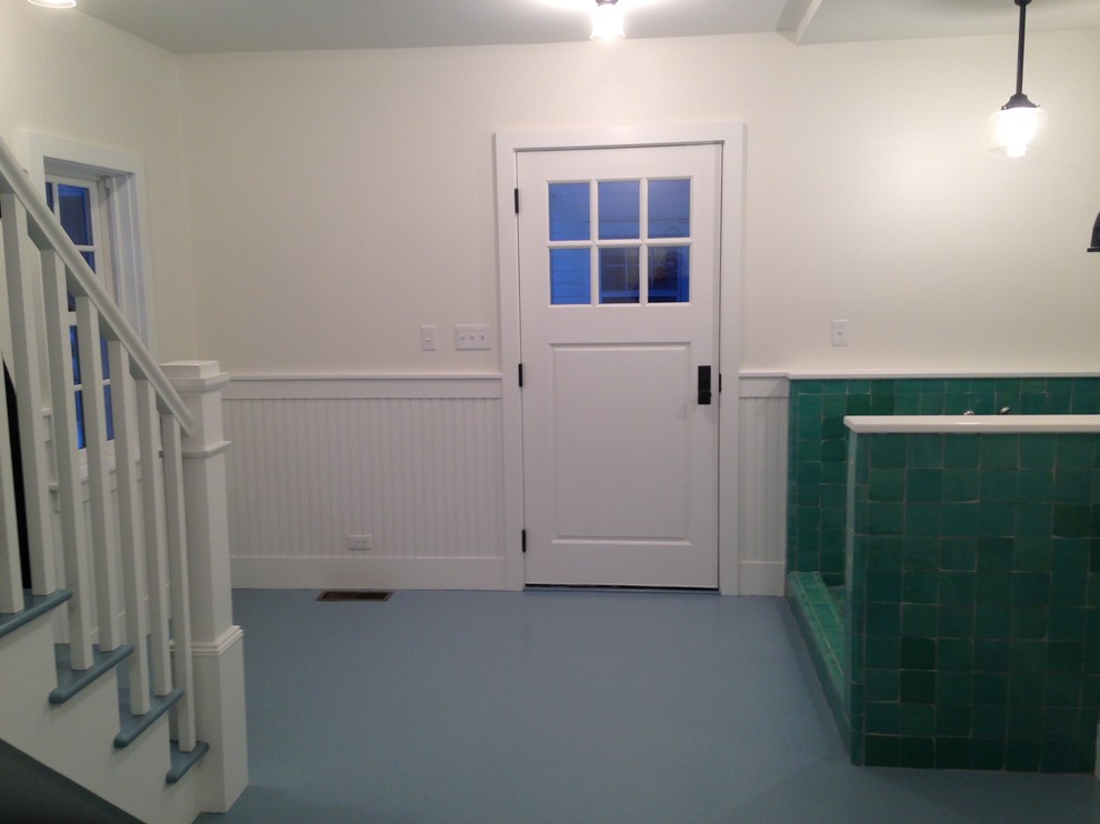 This is an example of a large transitional mudroom in New York with white walls, painted wood floors, a pivot front door and a white front door.