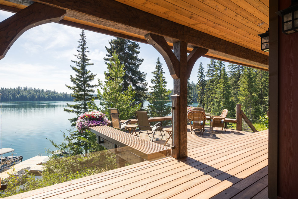 Inspiration for a mid-sized rustic backyard deck remodel in Jackson with decking and a roof extension