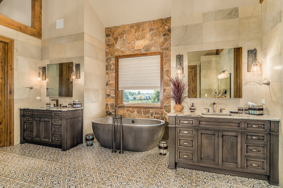 Design ideas for a country master bathroom in Chicago with recessed-panel cabinets, dark wood cabinets, a freestanding tub, beige tile, an undermount sink, multi-coloured floor and beige benchtops.