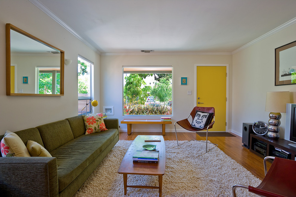 Design ideas for a mid-sized midcentury living room in Los Angeles with bamboo floors and white walls.