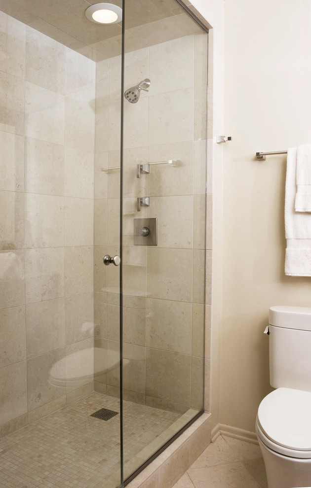 Mid-sized traditional 3/4 bathroom in Chicago with an alcove shower, a one-piece toilet, beige tile, limestone, beige walls, limestone floors, beige floor and a sliding shower screen.