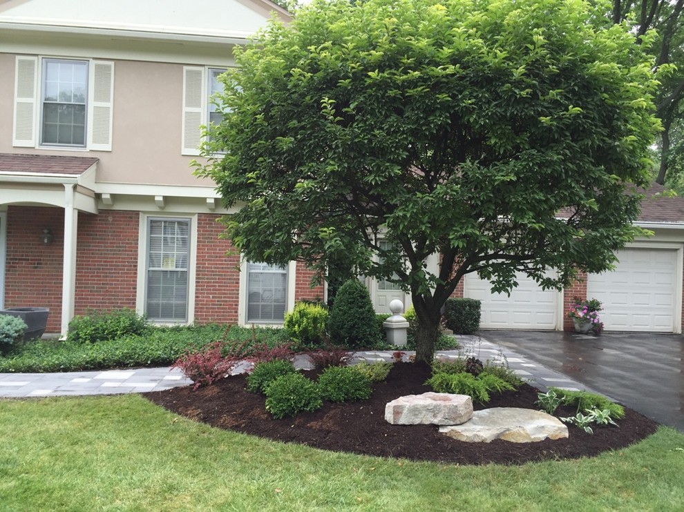Photo of a large transitional front yard full sun formal garden in Chicago with a garden path and natural stone pavers.