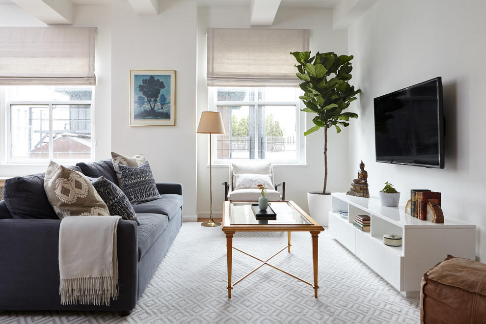Transitional open concept family room in New York with white walls, medium hardwood floors and a wall-mounted tv.