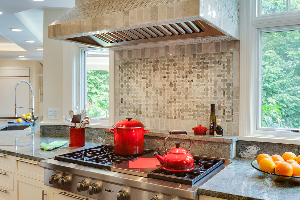Open concept kitchen - large transitional galley medium tone wood floor open concept kitchen idea in Boston with an undermount sink, shaker cabinets, white cabinets, granite countertops, multicolored backsplash, stone slab backsplash, stainless steel appliances and a peninsula