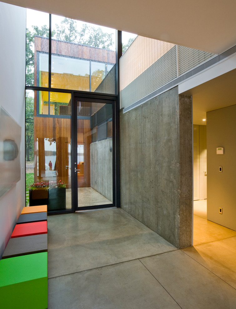 Design ideas for a modern entryway in Omaha with concrete floors.