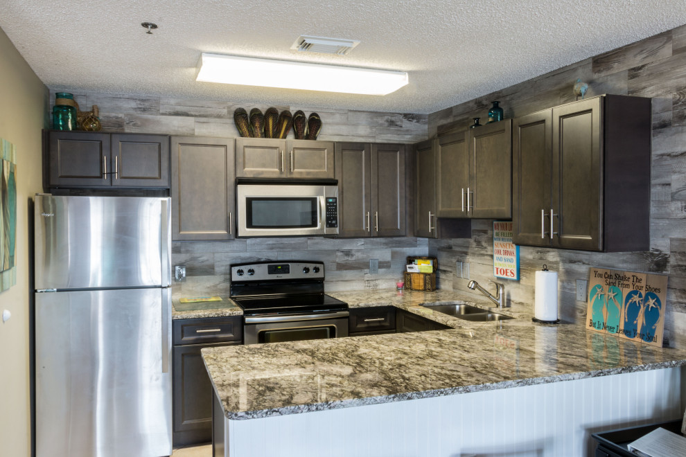 Example of a small mountain style u-shaped cement tile floor and beige floor eat-in kitchen design with an undermount sink, flat-panel cabinets, medium tone wood cabinets, granite countertops, gray backsplash, ceramic backsplash, stainless steel appliances, a peninsula and gray countertops