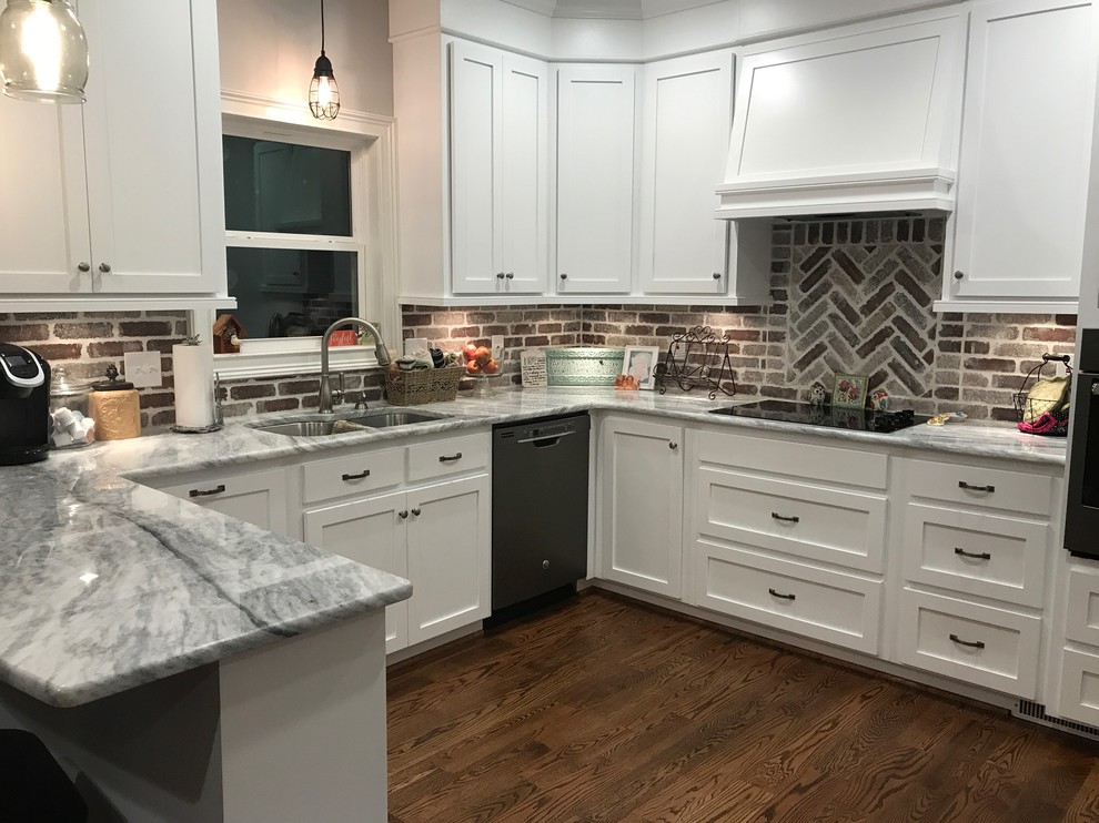 Large transitional u-shaped medium tone wood floor and brown floor eat-in kitchen photo in Birmingham with a double-bowl sink, shaker cabinets, white cabinets, multicolored backsplash, stainless steel appliances and a peninsula