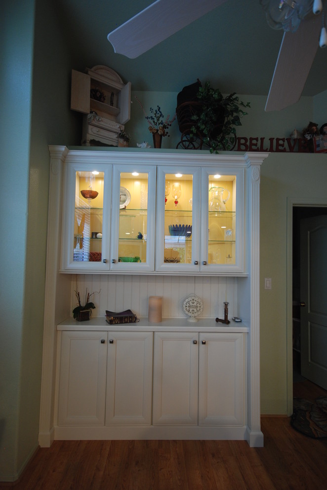 Example of a transitional kitchen design with flat-panel cabinets and white cabinets