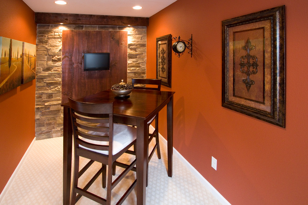 Photo of a mid-sized country look-out basement in Denver with carpet and orange walls.