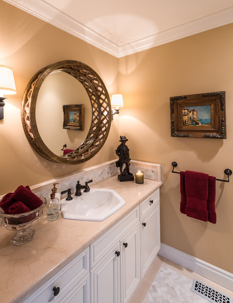 Design ideas for a mid-sized traditional master bathroom in San Francisco with raised-panel cabinets, white cabinets, a drop-in tub, an open shower, a one-piece toilet, beige tile, stone slab, beige walls, porcelain floors, a drop-in sink and solid surface benchtops.