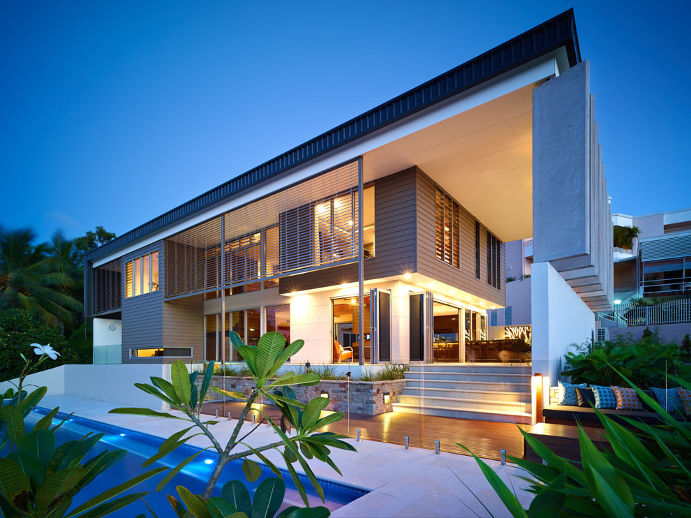 Expansive contemporary two-storey beige exterior in Darwin with wood siding and a flat roof.