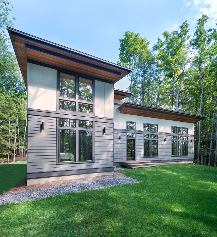 Mid-sized contemporary two-storey grey exterior in Boston with concrete fiberboard siding and a shed roof.