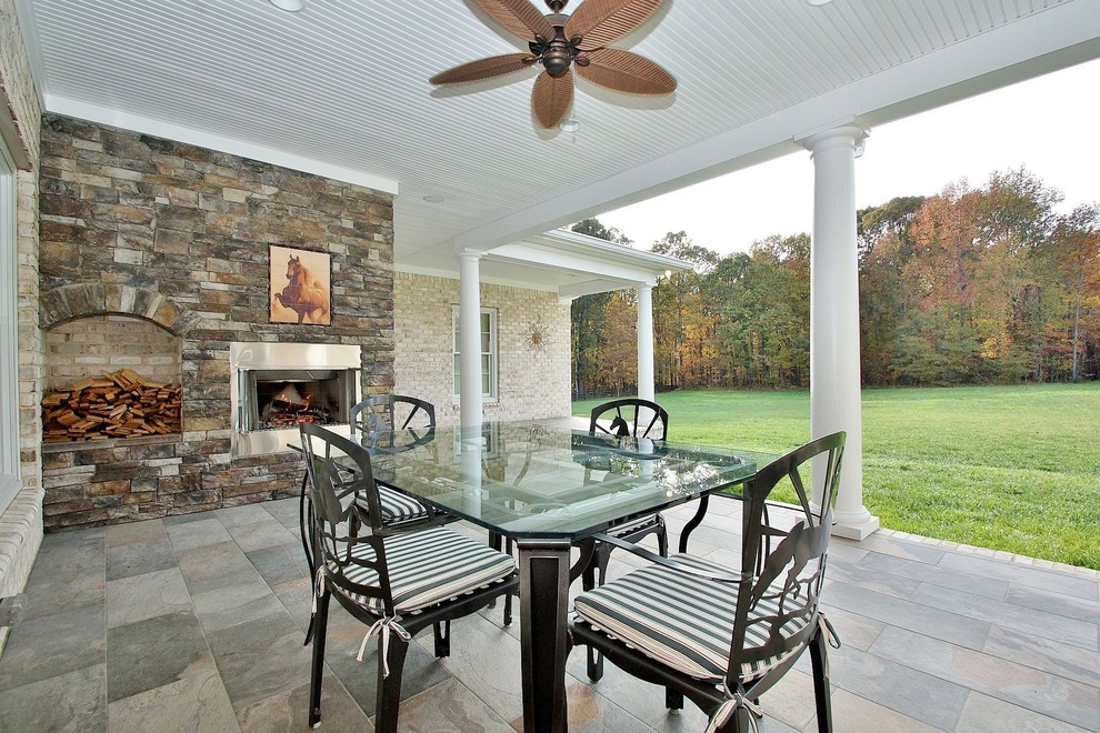 Photo of a large traditional backyard full sun garden for spring in Other with a fire feature and natural stone pavers.