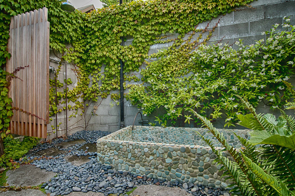 Eclectic backyard garden in Portland with a vertical garden.