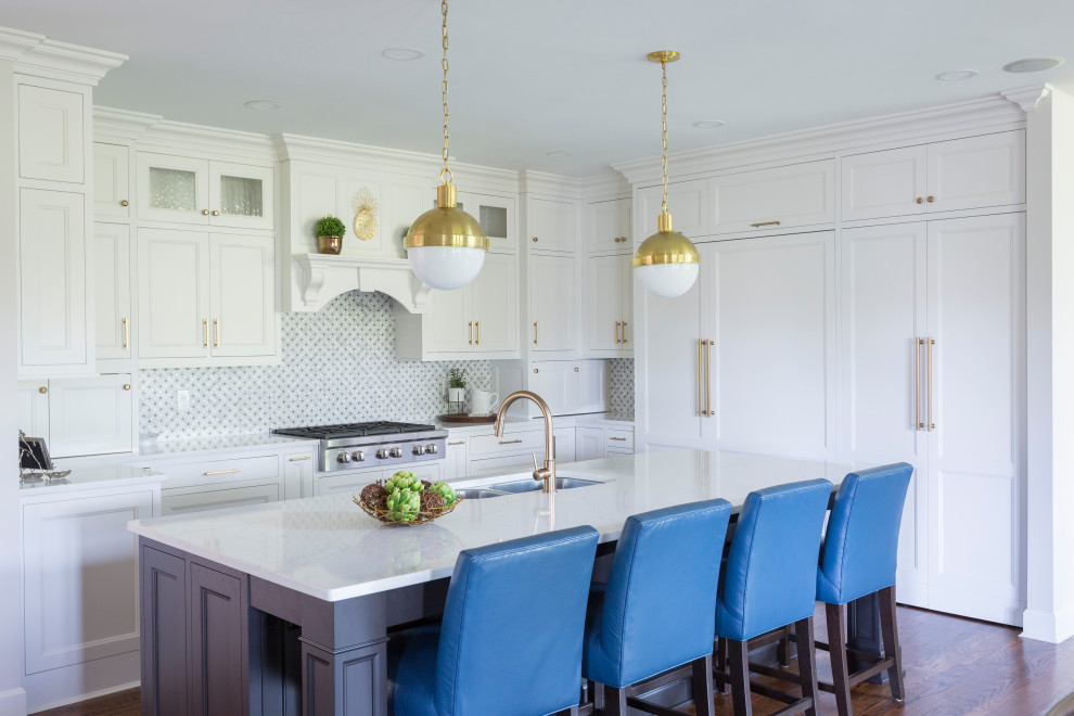 Inspiration for a large transitional l-shaped medium tone wood floor and brown floor kitchen remodel in Cincinnati with an undermount sink, shaker cabinets, white cabinets, multicolored backsplash, paneled appliances, an island and white countertops