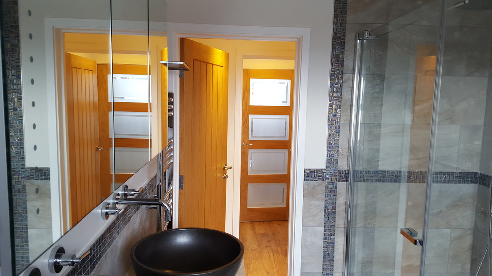 This is an example of a mid-sized contemporary master bathroom in Other with dark wood cabinets, a freestanding tub, an open shower, beige tile, stone tile, beige walls, porcelain floors, a vessel sink and limestone benchtops.